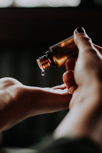 Essential oil being poured into palm