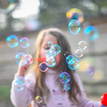 Child blowing bubbles